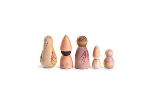 Five small, hand-painted wooden figures arranged in a row on a white background. Each figure is unique, with soft pastel colors and natural wood tones. The designs include simple, abstract features, such as engraved patterns resembling plants, a bird, and a crescent moon. The figures have various shapes and sizes, from rounded to conical, evoking a whimsical and nature-inspired aesthetic.